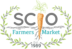 Logo for SCIO Farmers Market featuring a carrot forming the letter 'I' in SCIO, surrounded by a green laurel wreath. The words 'Farmers Market' appear below in blue, with 'Est. 1989' centered at the bottom.